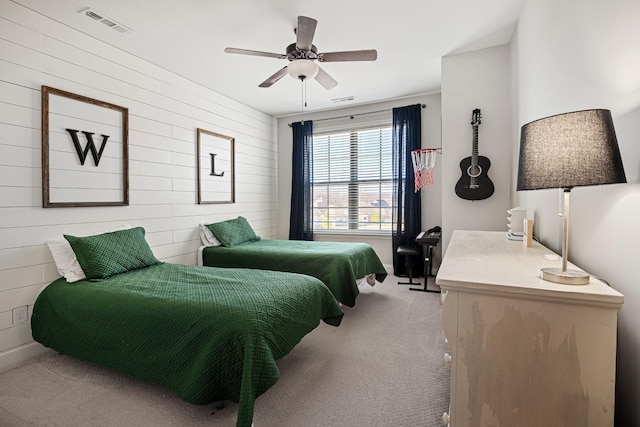 bedroom featuring visible vents, a ceiling fan, and light colored carpet