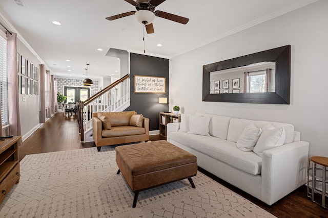 living room featuring ornamental molding, stairway, baseboards, and dark wood-style floors