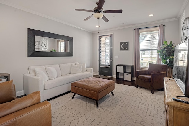 living room featuring baseboards, a ceiling fan, crown molding, light wood-type flooring, and recessed lighting