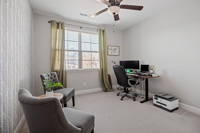 carpeted office with baseboards, visible vents, and ceiling fan