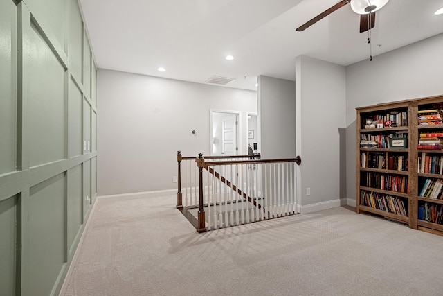 corridor featuring light carpet, visible vents, an upstairs landing, and recessed lighting