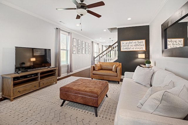 living room featuring stairway, baseboards, visible vents, and ornamental molding