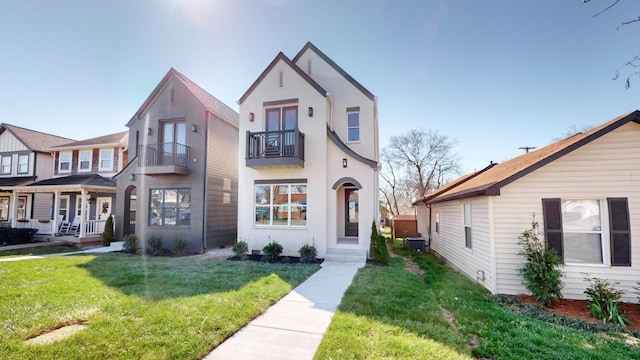 view of front of property with cooling unit, brick siding, and a front yard