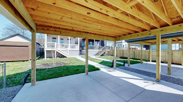 view of patio featuring stairs, a shed, an outdoor structure, and fence