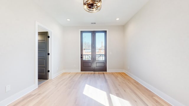 doorway featuring recessed lighting, french doors, light wood-style flooring, and baseboards