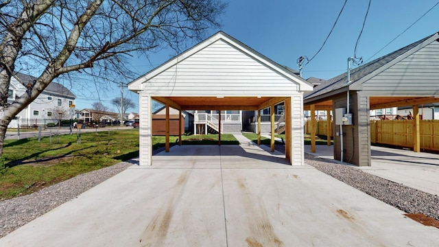 exterior space featuring a yard, a carport, and fence