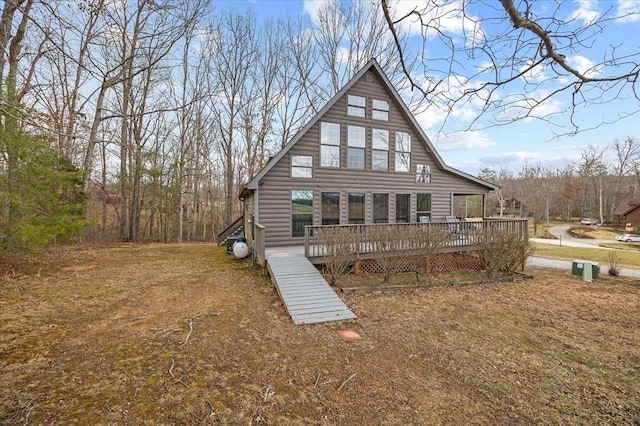 rear view of house featuring a wooden deck