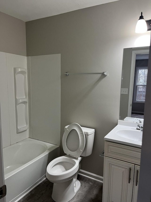 bathroom with baseboards, tub / shower combination, vanity, and toilet