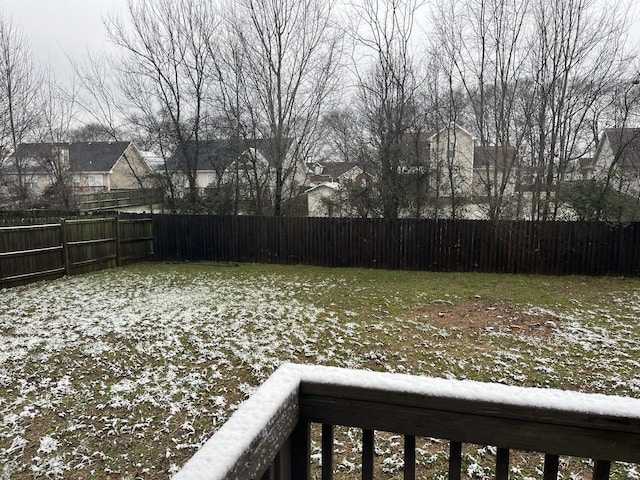 yard covered in snow featuring a fenced backyard