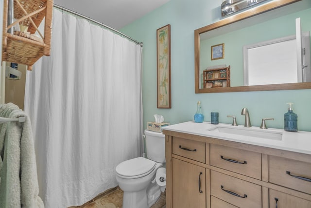 full bathroom featuring toilet and vanity