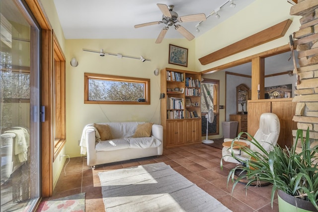 sitting room featuring dark tile patterned floors, track lighting, vaulted ceiling, and a ceiling fan