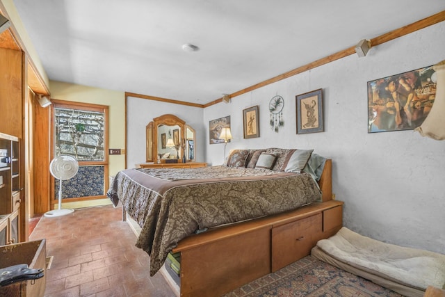 bedroom with a textured wall, brick floor, and crown molding