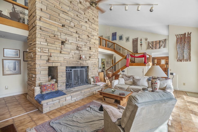 living room with high vaulted ceiling, a fireplace, baseboards, and light tile patterned floors