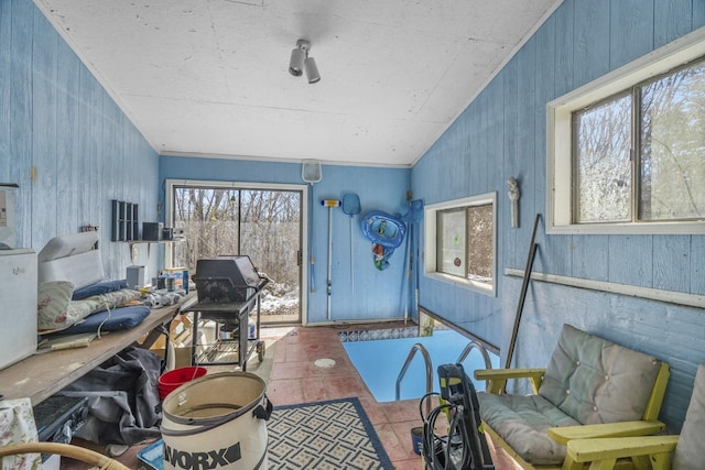 office space with vaulted ceiling and tile patterned floors