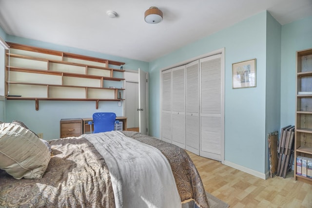 bedroom featuring a closet, baseboards, and light wood finished floors