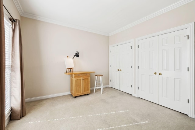 bedroom with light carpet, crown molding, baseboards, and two closets