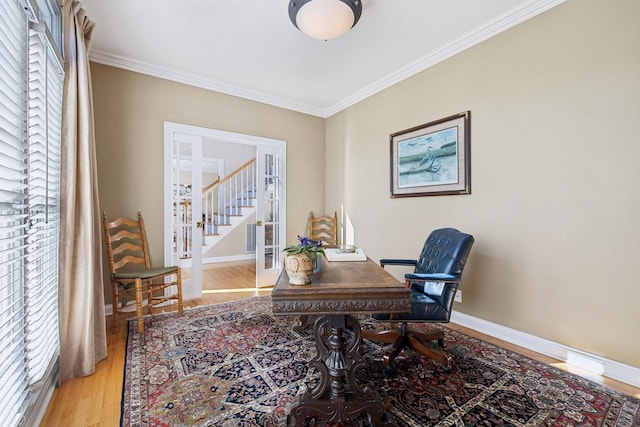 office with light wood-style floors, baseboards, french doors, and ornamental molding