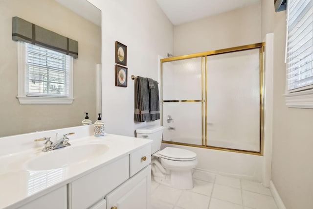 full bathroom with tile patterned flooring, combined bath / shower with glass door, vanity, and toilet