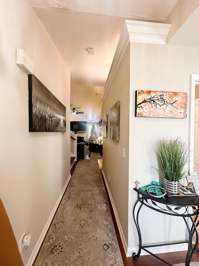 corridor featuring ornamental molding and baseboards