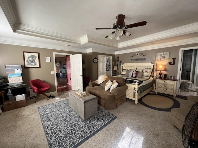 bedroom with a raised ceiling and a ceiling fan