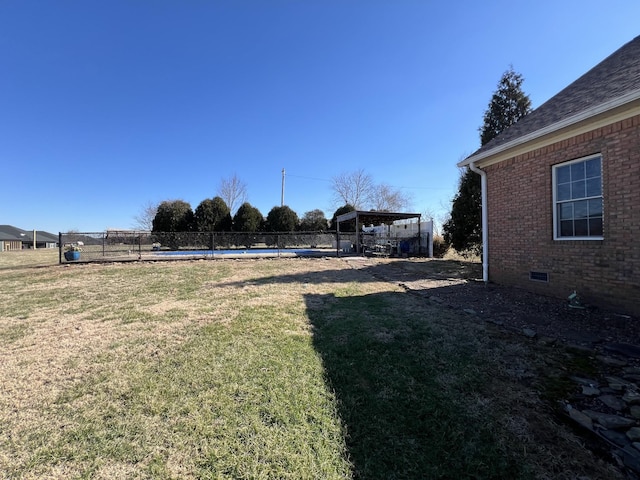 view of yard with fence and a fenced in pool