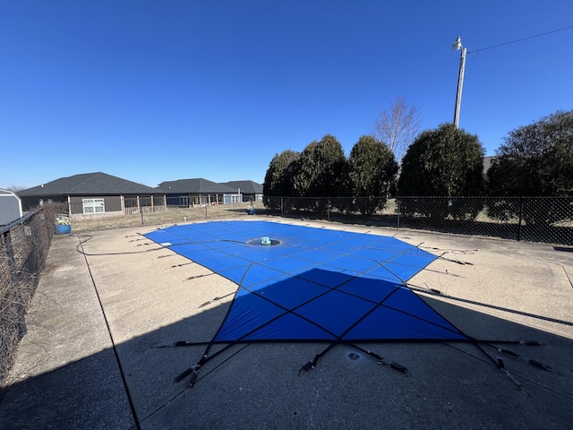 view of pool featuring a patio area, fence, and a fenced in pool