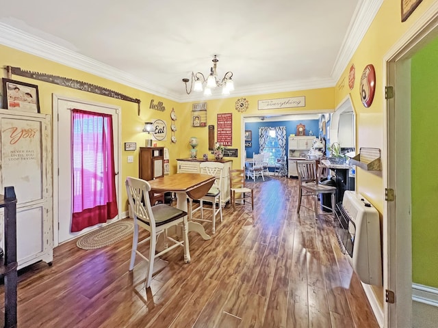 325 Davis Mill Rd, Elkton, KY 42220 - dining area featuring wood finished floors, a chandelier, ornamental molding, and heating unit