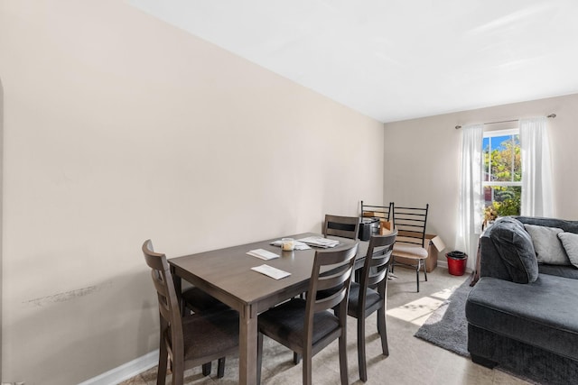 dining space featuring baseboards