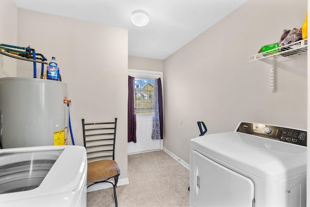 washroom with laundry area, water heater, baseboards, and independent washer and dryer