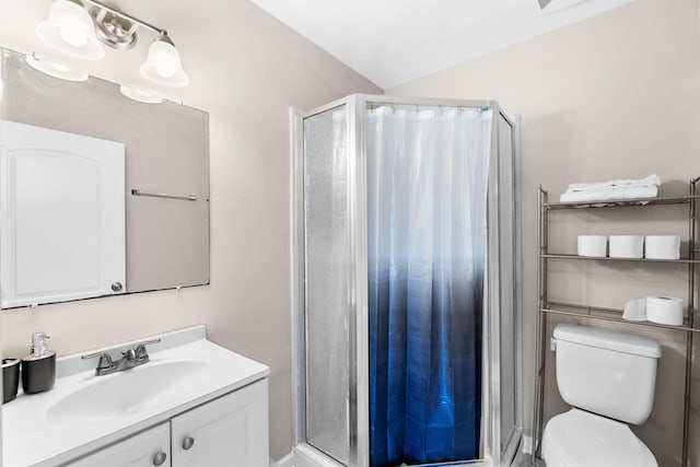 full bath featuring a stall shower, vanity, and toilet