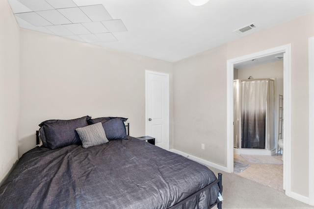 bedroom with carpet, ensuite bath, visible vents, and baseboards