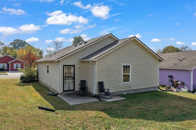 rear view of house with a yard and a patio area