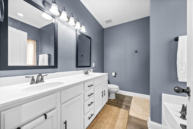 full bath featuring baseboards, visible vents, a sink, and wood finished floors