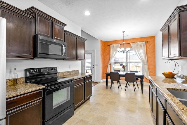 kitchen featuring black electric range oven, hanging light fixtures, stone countertops, dark brown cabinets, and a chandelier