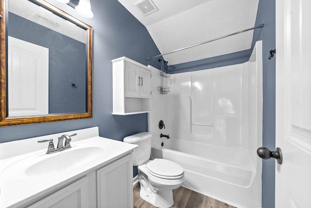 bathroom featuring visible vents, toilet, washtub / shower combination, vanity, and wood finished floors