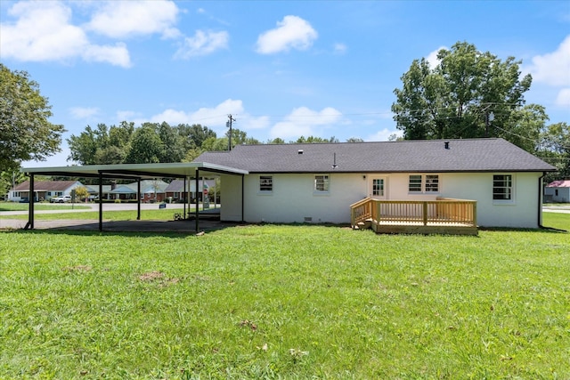 back of property featuring a deck, crawl space, an attached carport, and a lawn