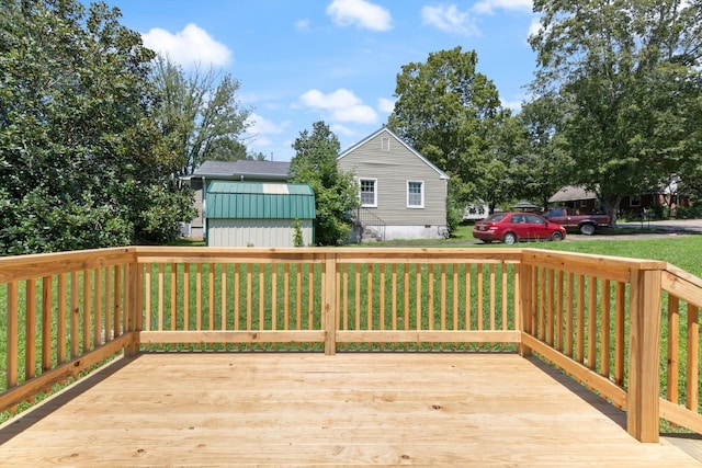 wooden deck featuring a lawn