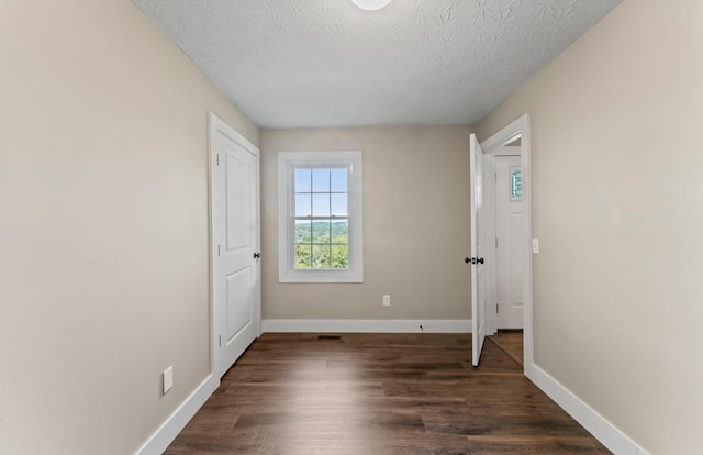 224 Kempville Hwy, Carthage, TN 37030 - spare room with dark wood-style floors, baseboards, and a textured ceiling