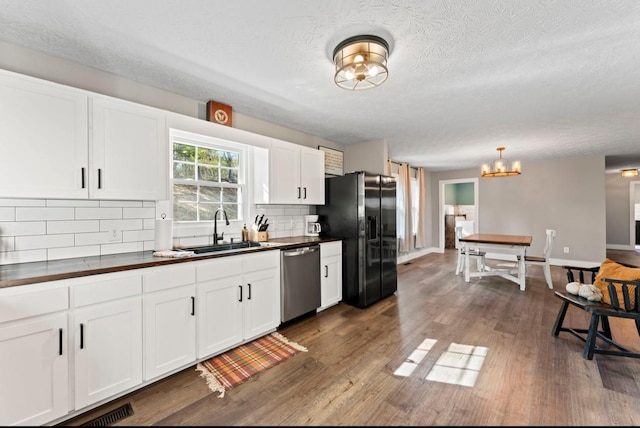224 Kempville Hwy, Carthage, TN 37030 - kitchen with dishwasher, black fridge, a sink, and white cabinets