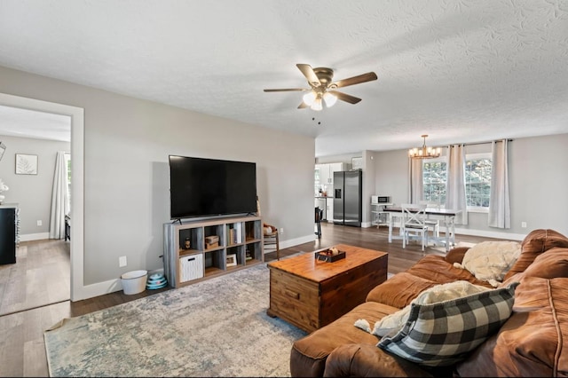 224 Kempville Hwy, Carthage, TN 37030 - living area with ceiling fan with notable chandelier, a textured ceiling, baseboards, and wood finished floors