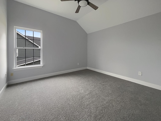 unfurnished room with baseboards, vaulted ceiling, and a ceiling fan