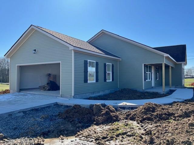 view of side of home with a garage and driveway