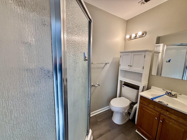 full bath with baseboards, toilet, wood finished floors, vanity, and a shower stall