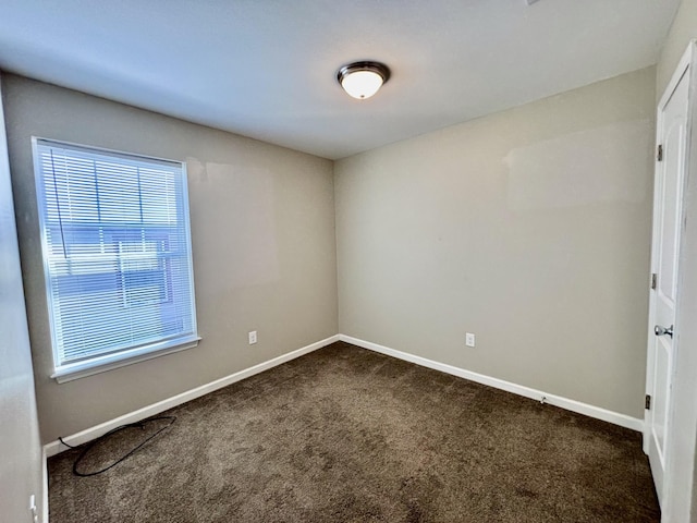 spare room with carpet flooring and baseboards