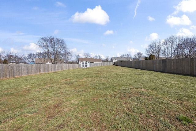 view of yard with a fenced backyard and an outdoor structure