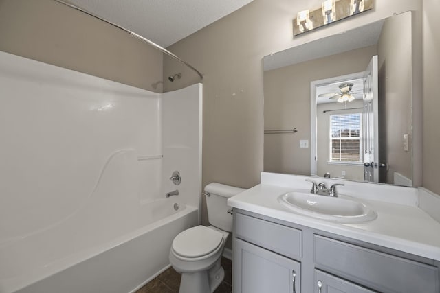 bathroom featuring washtub / shower combination, vanity, toilet, and a ceiling fan