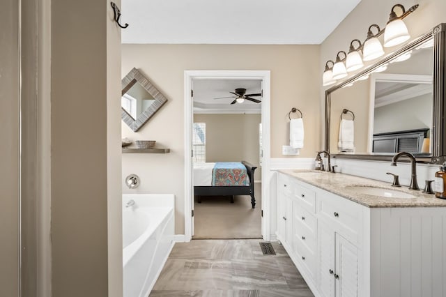 ensuite bathroom featuring double vanity, ensuite bath, a sink, and a bath