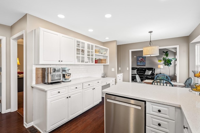 kitchen with dark wood-type flooring, white cabinetry, decorative backsplash, and stainless steel dishwasher