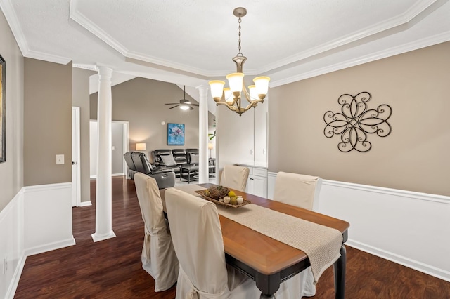 dining room with lofted ceiling, ceiling fan with notable chandelier, wood finished floors, ornate columns, and crown molding