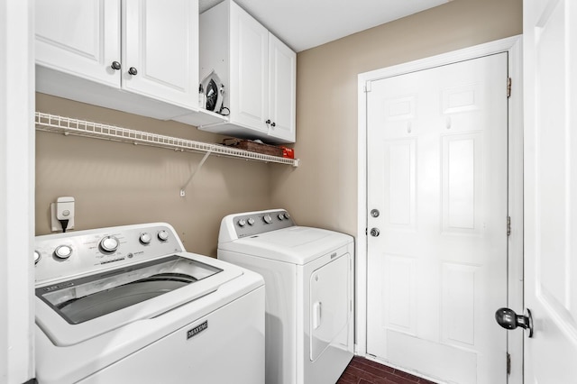 washroom featuring cabinet space and washing machine and clothes dryer